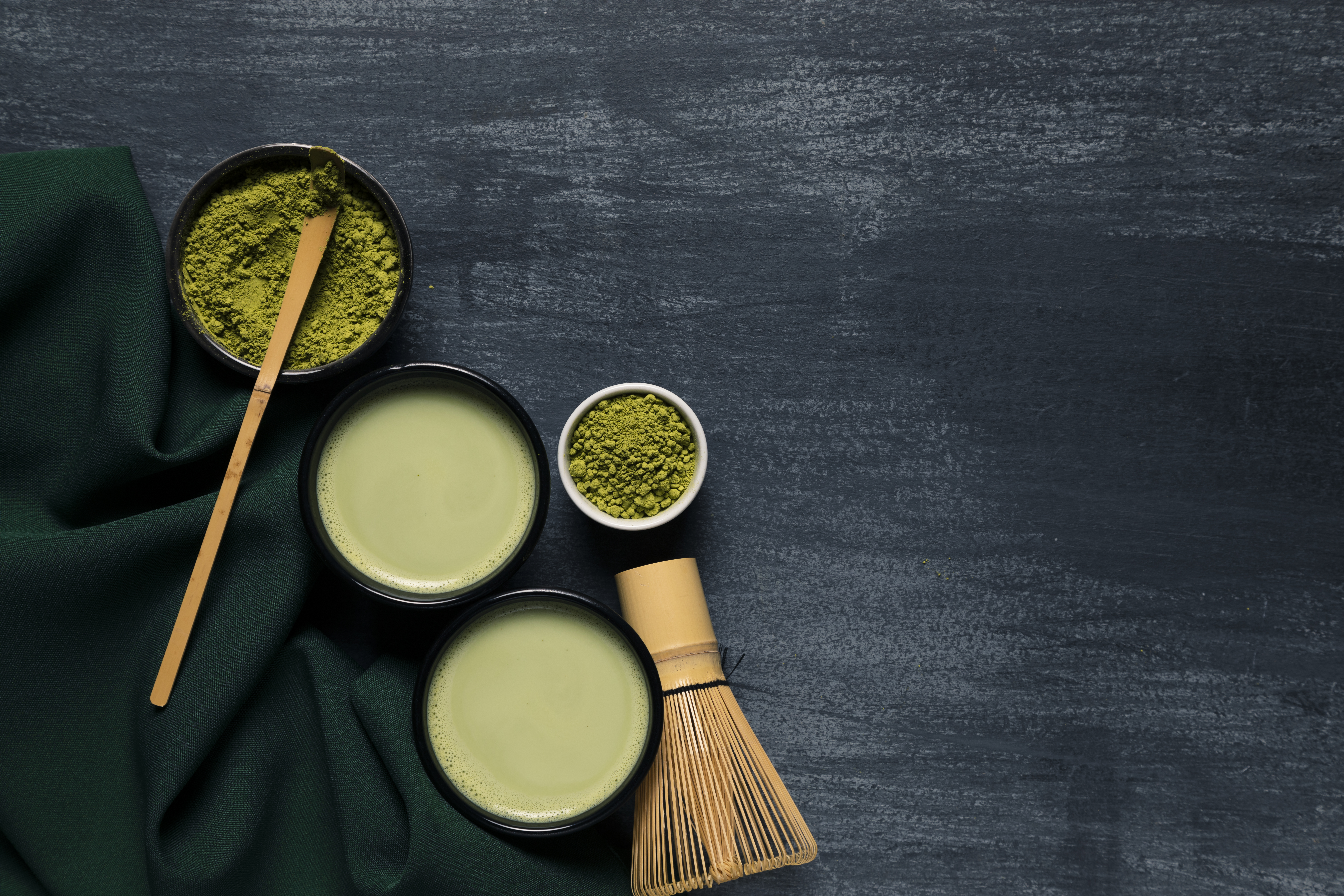 Botanical ingredients arranged on a dark clinical surface